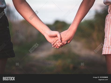 2 women holding hands